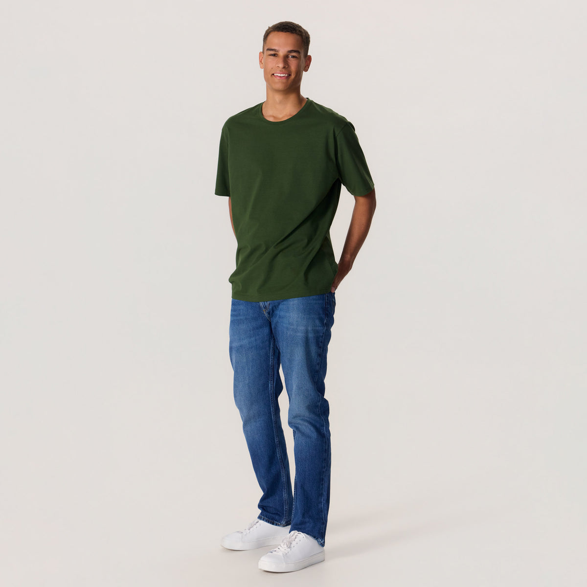 Miesmalli maastonvihreässä unisex-mallisessa t-paidassa, missä pyöreä pääntie
